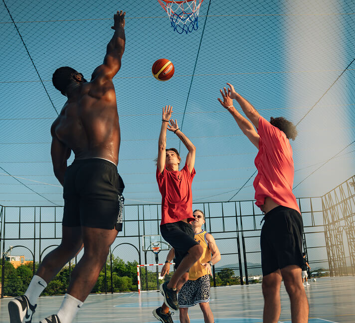 People playing basketball on the LUDUS rooftop court