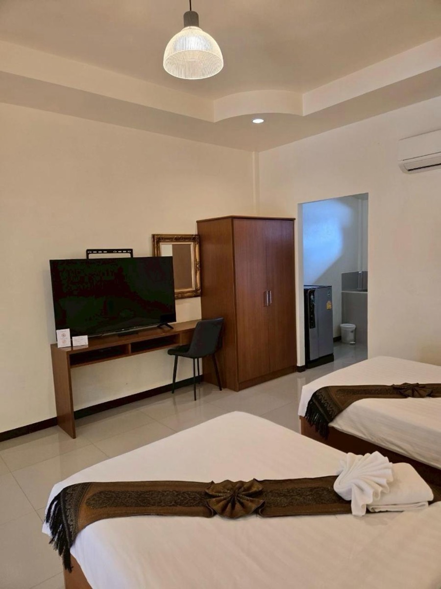 The desk and TV side of the room, with the bathroom door open